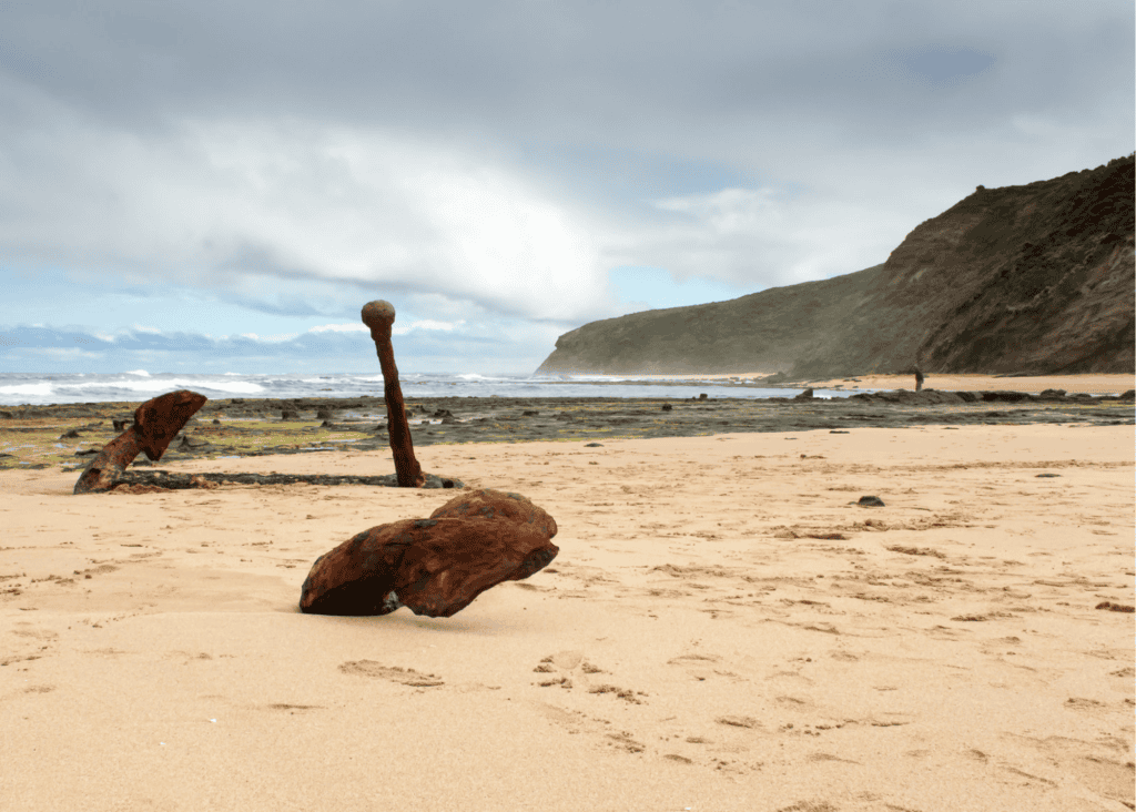 Beach with wrecked rusty anchor