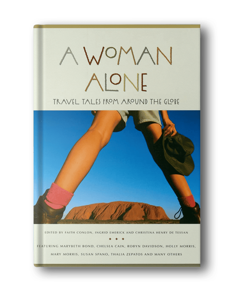 Cover of a book titled "A Woman Alone: Travel Tales from Around the Globe," featuring a photo of a woman in hiking shorts and socks, with an edited byline and contributing authors listed. Perfect for anyone seeking adventure books for women that inspire solo travel.